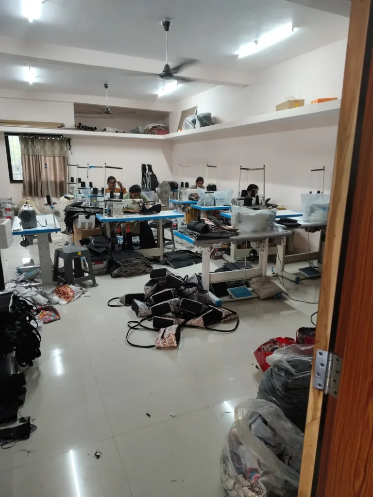 Bag production floor with sewing stations and cut fabric panels